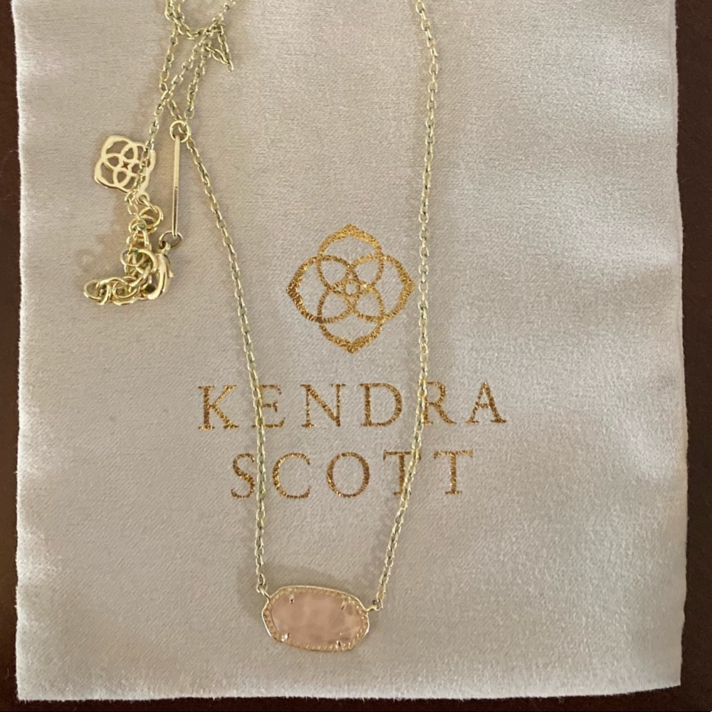 Kendra Scott small light pink gold necklace.